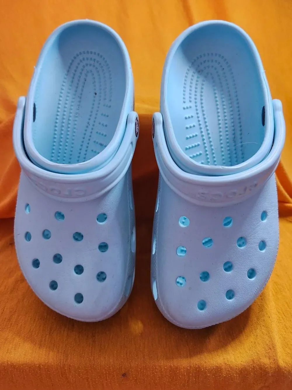 Crocs Classic clogs feature the iconic ventilated design and a swivel heel strap